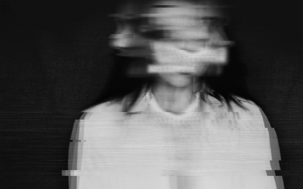 black and white distorted photo of a woman in movement